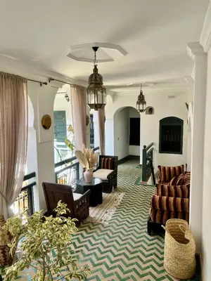 a large living room with couches and chairs at Riad Ecila in Marrakech