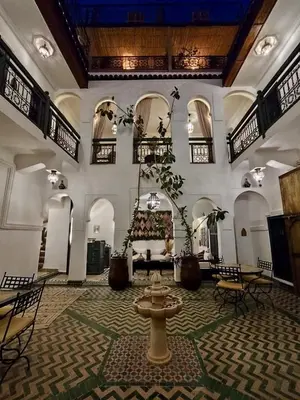 a large room with a fountain in the middle of it at Riad Ecila in Marrakech