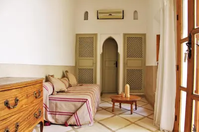 a room with a couch and a table and a door at Riad Miski in Marrakech