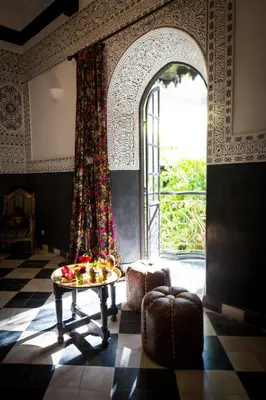 a room with a table and a large window at Riad Dar Jaguar in Marrakech