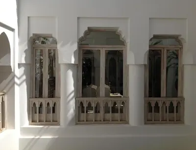 three windows on the side of a white building at Riad Safa in Marrakech