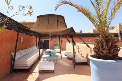 a patio with a gazebo and a table and chairs at Riad Julia in Marrakech