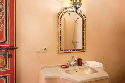 a bathroom with a sink and a mirror at Riad Julia in Marrakech
