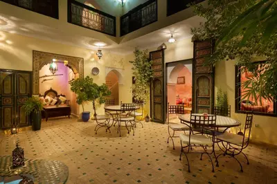 a large room with tables and chairs and a couch at Riad Julia in Marrakech