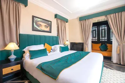 a bedroom with a large bed with a green headboard at Janat Al Atlas Resort & Spa in Marrakech