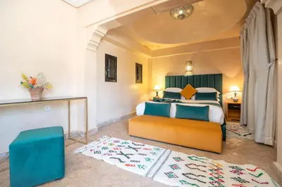 a bedroom with a bed and a table in a room at Janat Al Atlas Resort & Spa in Marrakech