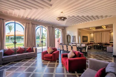 a living room with couches and a dining room at Janat Al Atlas Resort & Spa in Marrakech