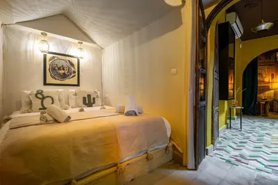 a bedroom with a large bed in a room at Dar Khmissa Riad & Spa in Marrakech