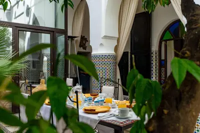 a dining room with a table with food on it at Riad Dar Dialkoum in Marrakech