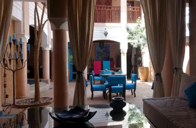 a living room with a couch and a table and chairs at Riad Turquoise in Marrakech