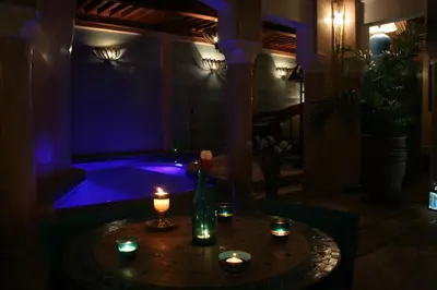 a room with a table with candles and a tub at Riad Turquoise in Marrakech