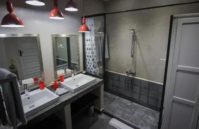 a bathroom with two sinks and a shower at Riad Shanima SPA Marrakech in Marrakech