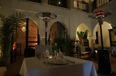 a restaurant with a table with a white table cloth at Riad Shanima SPA Marrakech in Marrakech