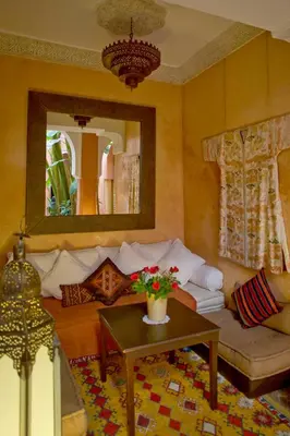 a living room with a couch and a table at Dar Attajmil in Marrakech