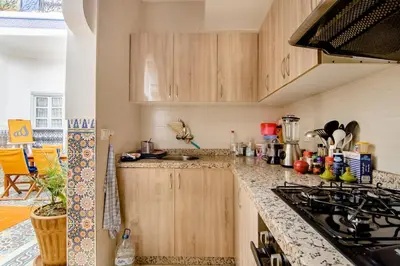 a kitchen with wooden cabinets and a counter top at Riad Medina in Marrakech