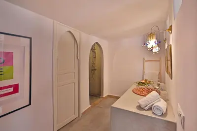 a room with a table with towels and a door at Riad la Parenthèse by Sashema in Marrakech