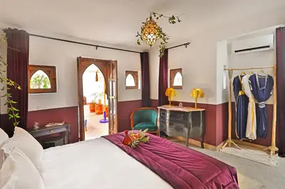 a bedroom with a bed and a desk and a mirror at Riad la Parenthèse by Sashema in Marrakech