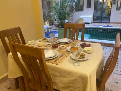 a table with plates and bowls of food on it at Riad Samarine in Marrakech