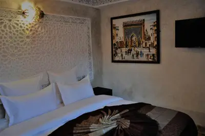 a bedroom with a bed and a picture on the wall at Riad Sania By Ghali in Marrakech