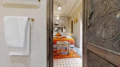 a door leading to a bedroom with a bed at Riad Sania By Ghali in Marrakech