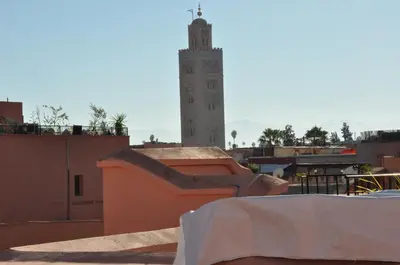 a building with a clock tower on top of a city at Riad Sania By Ghali in Marrakech