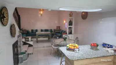 a kitchen with a table with a bowl of fruit on it at Riad Abdou in Marrakech