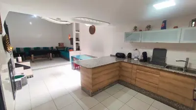 a kitchen with a counter and a living room at Riad Abdou in Marrakech