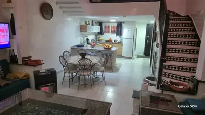 a kitchen and dining room with a table and chairs at Riad Abdou in Marrakech