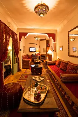 a living room with a couch and a table at Riad Cherihane in Marrakech