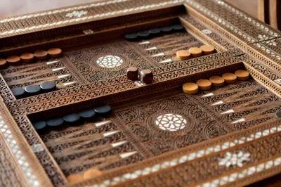 an open wooden chessboard with wooden buttons on it at La Villa des Orangers - Relais & Châteaux in Marrakech