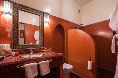 a bathroom with a sink and a mirror and a toilet at Riad Alaka in Marrakech
