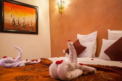 two stuffed animals are laying on a bed at Riad Alaka in Marrakech