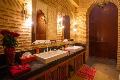 a bathroom with two sinks and a mirror at Riad Hizad in Marrakech