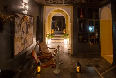a hallway of a house with chairs and lights at Riad Hizad in Marrakech