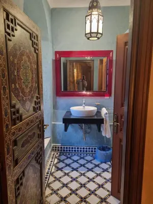 a bathroom with a sink and a mirror at Riyad Al Moussika in Marrakech