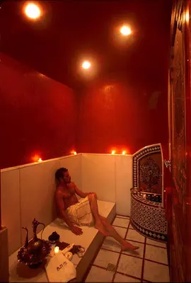 a man sitting in a bath tub in a room at Riyad Al Moussika in Marrakech