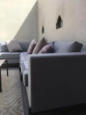 a blue couch with pillows in a living room at Riad Le Marrakech Berrima in Marrakech