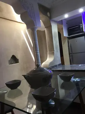 a glass table with a vase on top of it at Riad Le Marrakech Berrima in Marrakech