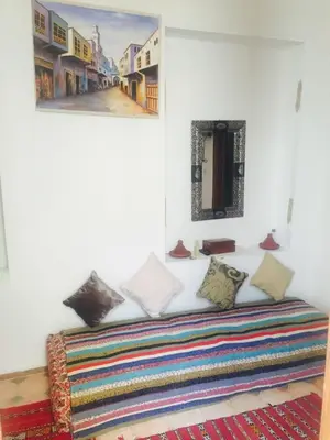 a room with a bed with a painting on the wall at Ryad Bianco in Marrakech