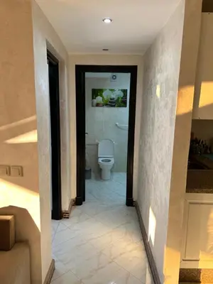 a hallway to a bathroom with a toilet in it at Susana home in Marrakech
