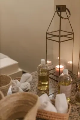 a table with a candle and a basket with a lantern at Riad M17 - Hammam & Spa in Marrakech