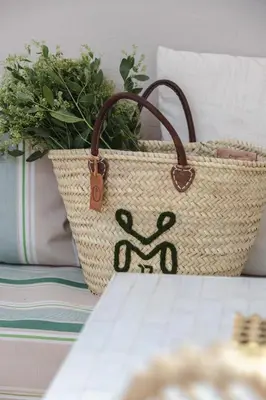 a rattan basket with a plant and a purse at Riad M17 - Hammam & Spa in Marrakech