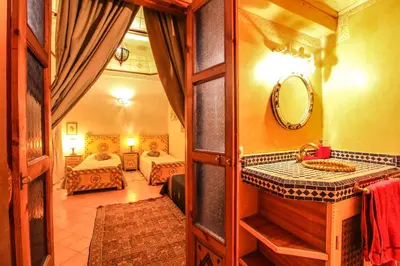 a bathroom with a sink and a mirror at Riad Puchka in Marrakech