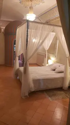 a bedroom with a bed with a canopy at Riad Puchka in Marrakech
