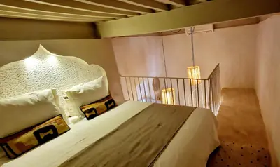 a bedroom with a bed with a headboard at Riad de Vincent in Marrakech