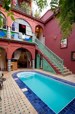 a house with a swimming pool in front of a building at Riad Wardate Rita in Marrakech