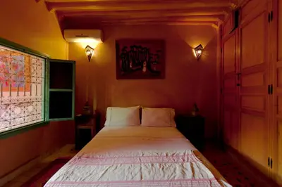 a bedroom with a bed in a room with a window at Riad Wardate Rita in Marrakech
