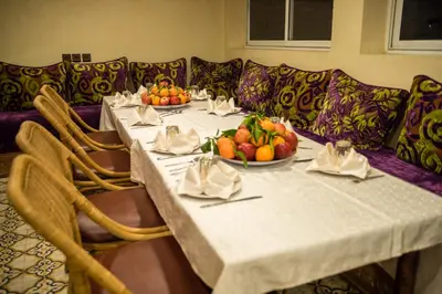 a table with fruit on it with a couch at Riad Omar in Marrakech