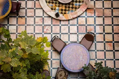 a pair of shoes and plants on a tiled floor at Riad Omar in Marrakech