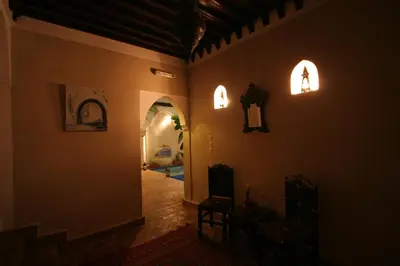 a hallway of a house with two lights on the wall at Riad Morgane in Marrakech
